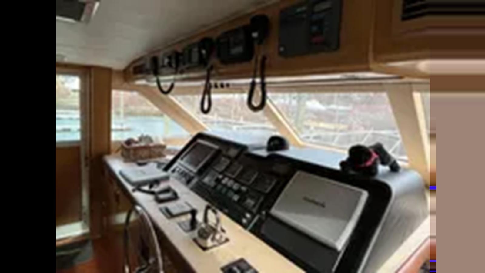a room with a keyboard and a laptop on a table aboard 1999 HATTERAS 74 SPORT DECK MOTOR YACHT Yacht for Sale