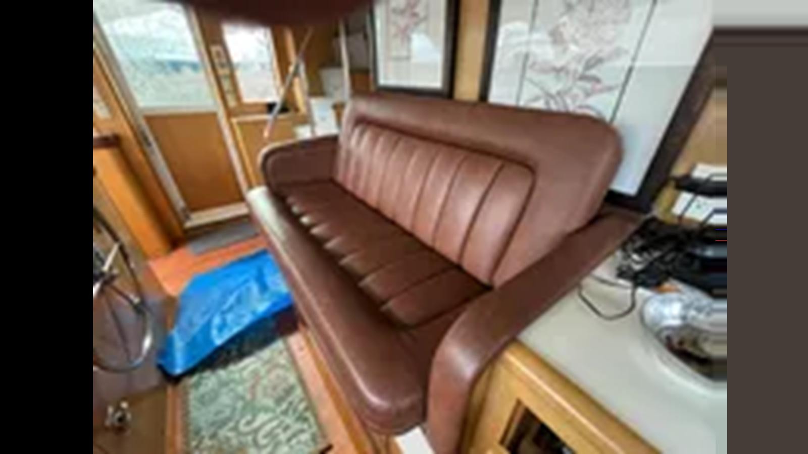 a couch in a room aboard 1999 HATTERAS 74 SPORT DECK MOTOR YACHT Yacht for Sale