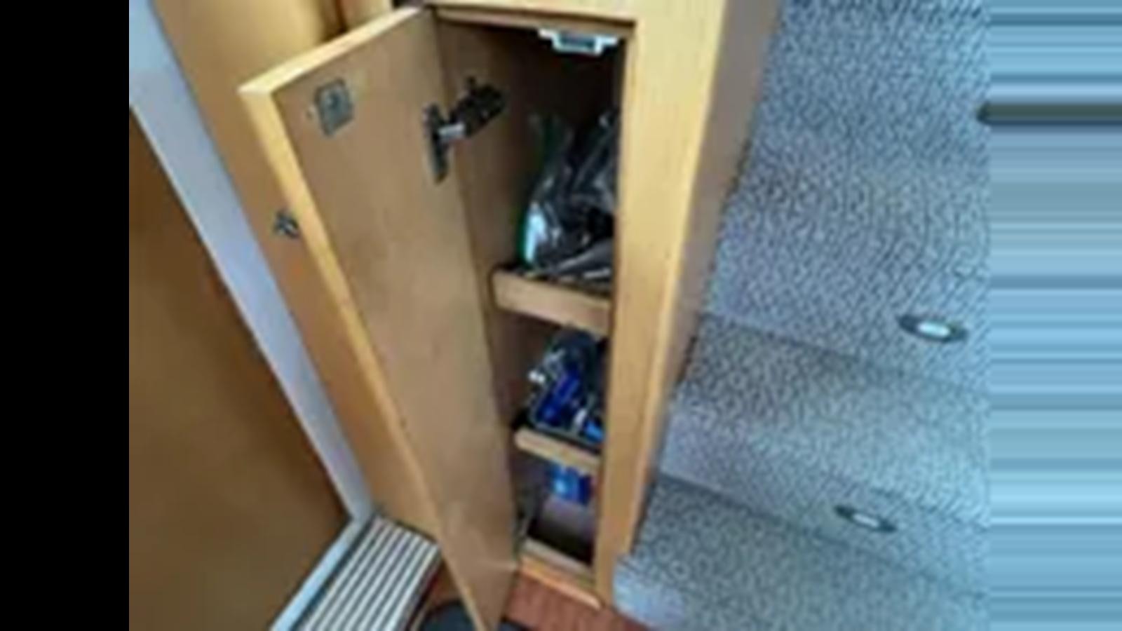 a closet with a door open aboard 1999 HATTERAS 74 SPORT DECK MOTOR YACHT Yacht for Sale