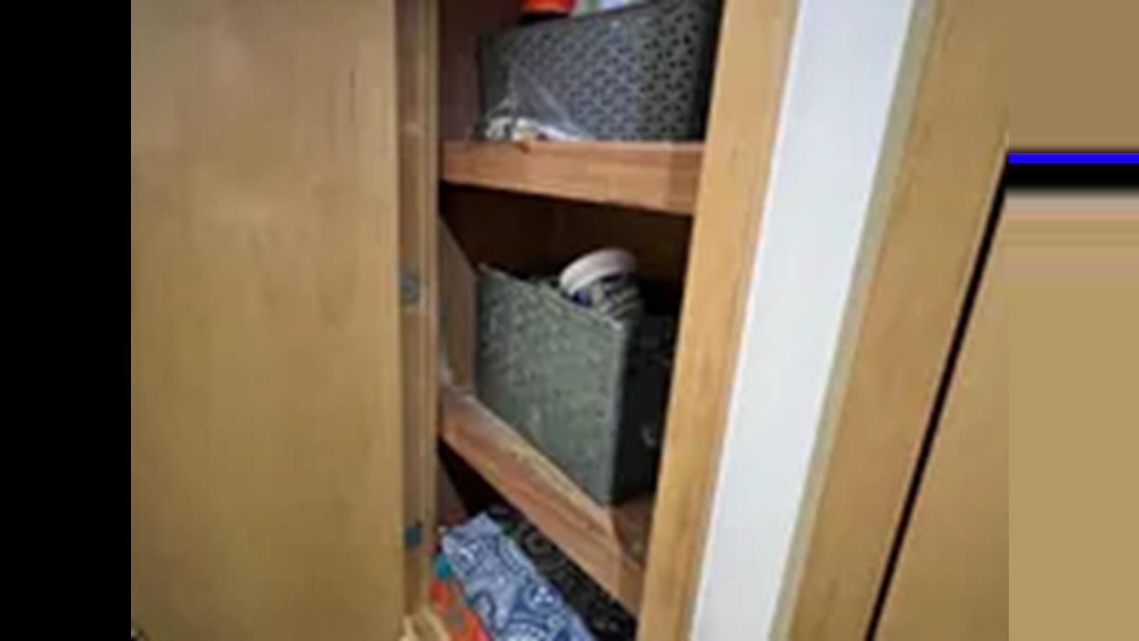 a small green box on a wooden shelf aboard 1999 HATTERAS 74 SPORT DECK MOTOR YACHT Yacht for Sale
