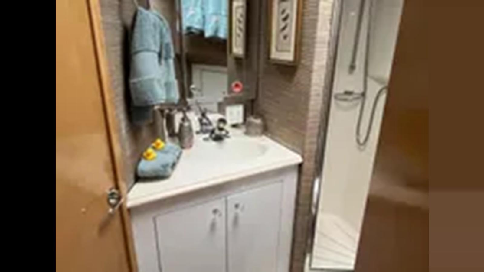 a bathroom with a towel on the wall aboard 1999 HATTERAS 74 SPORT DECK MOTOR YACHT Yacht for Sale