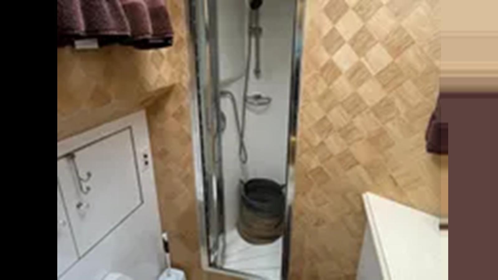 a shower with a bucket aboard 1999 HATTERAS 74 SPORT DECK MOTOR YACHT Yacht for Sale