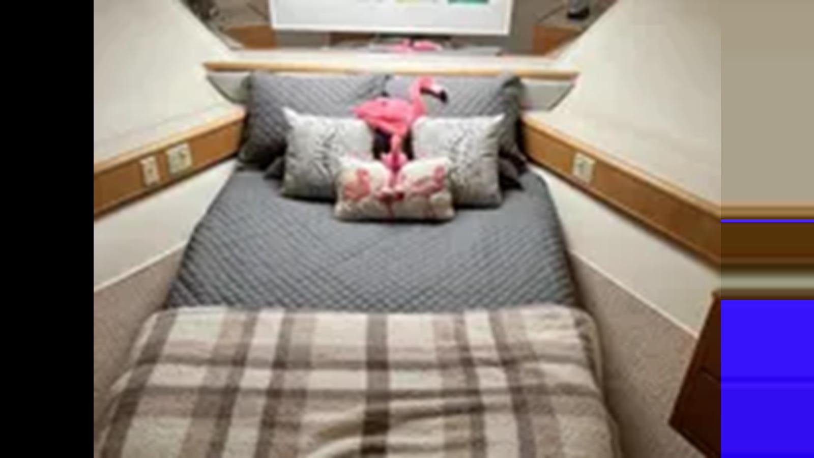 a stuffed animal on a bed aboard 1999 HATTERAS 74 SPORT DECK MOTOR YACHT Yacht for Sale