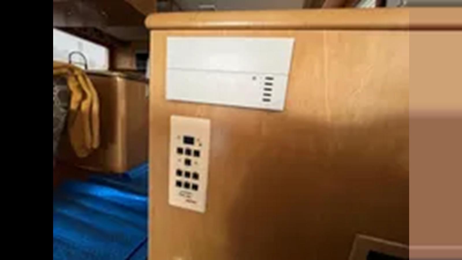 a white box with a cord aboard 1999 HATTERAS 74 SPORT DECK MOTOR YACHT Yacht for Sale