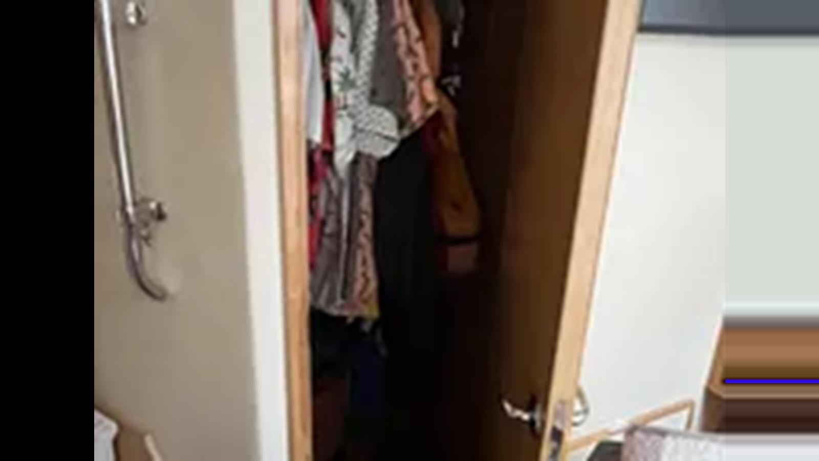 a closet with clothes on the wall aboard 1999 HATTERAS 74 SPORT DECK MOTOR YACHT Yacht for Sale