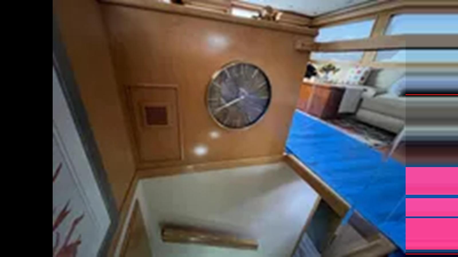 a clock on a wall aboard 1999 HATTERAS 74 SPORT DECK MOTOR YACHT Yacht for Sale