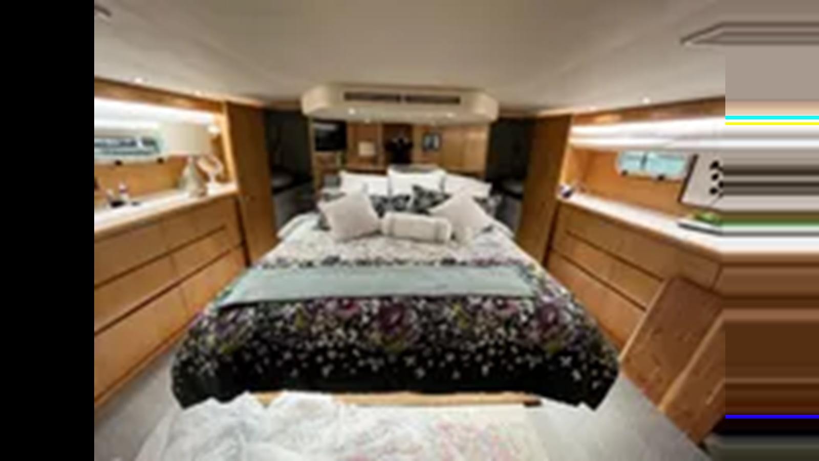 a bed in a room aboard 1999 HATTERAS 74 SPORT DECK MOTOR YACHT Yacht for Sale