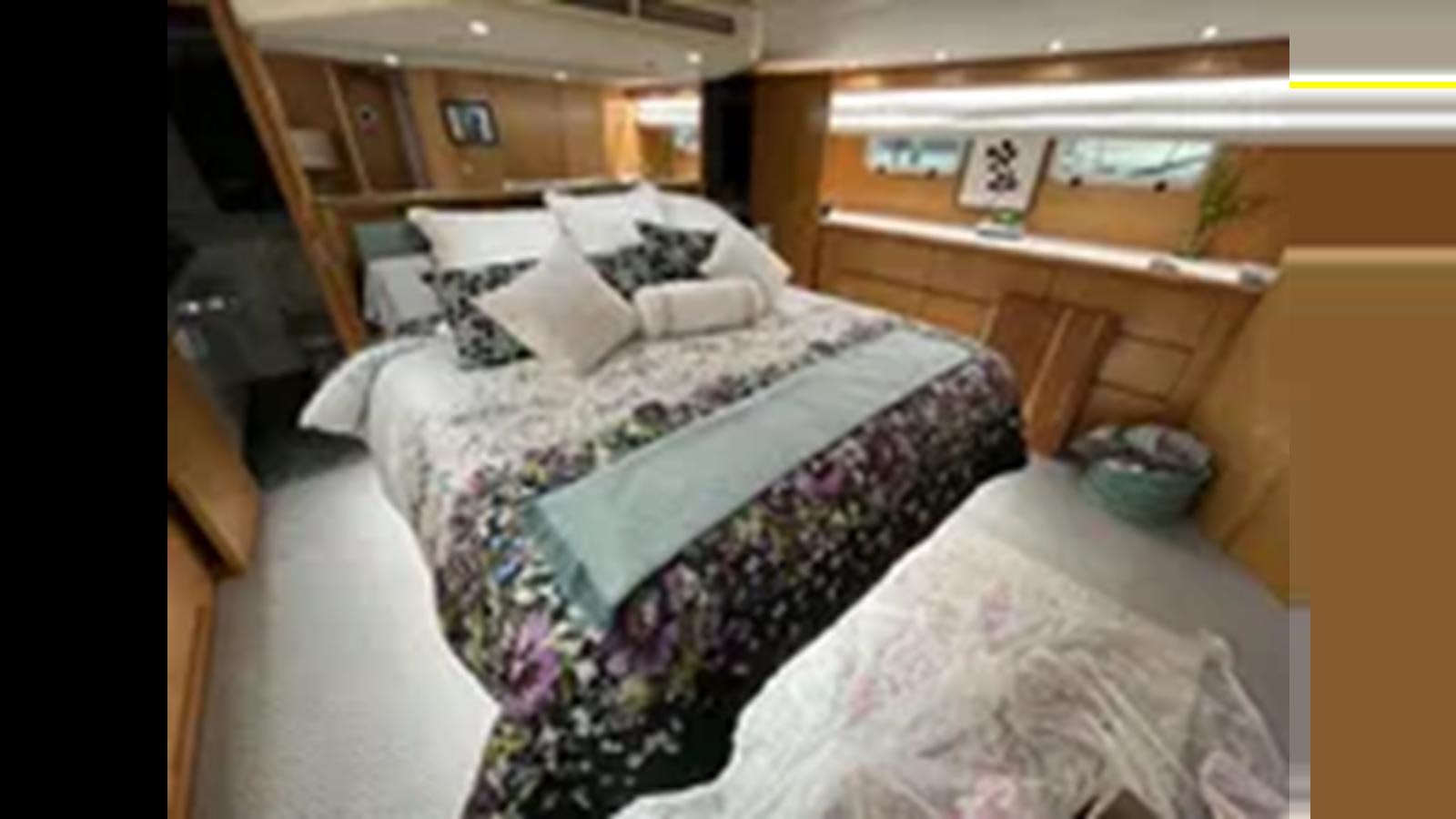 a bed with white sheets aboard 1999 HATTERAS 74 SPORT DECK MOTOR YACHT Yacht for Sale