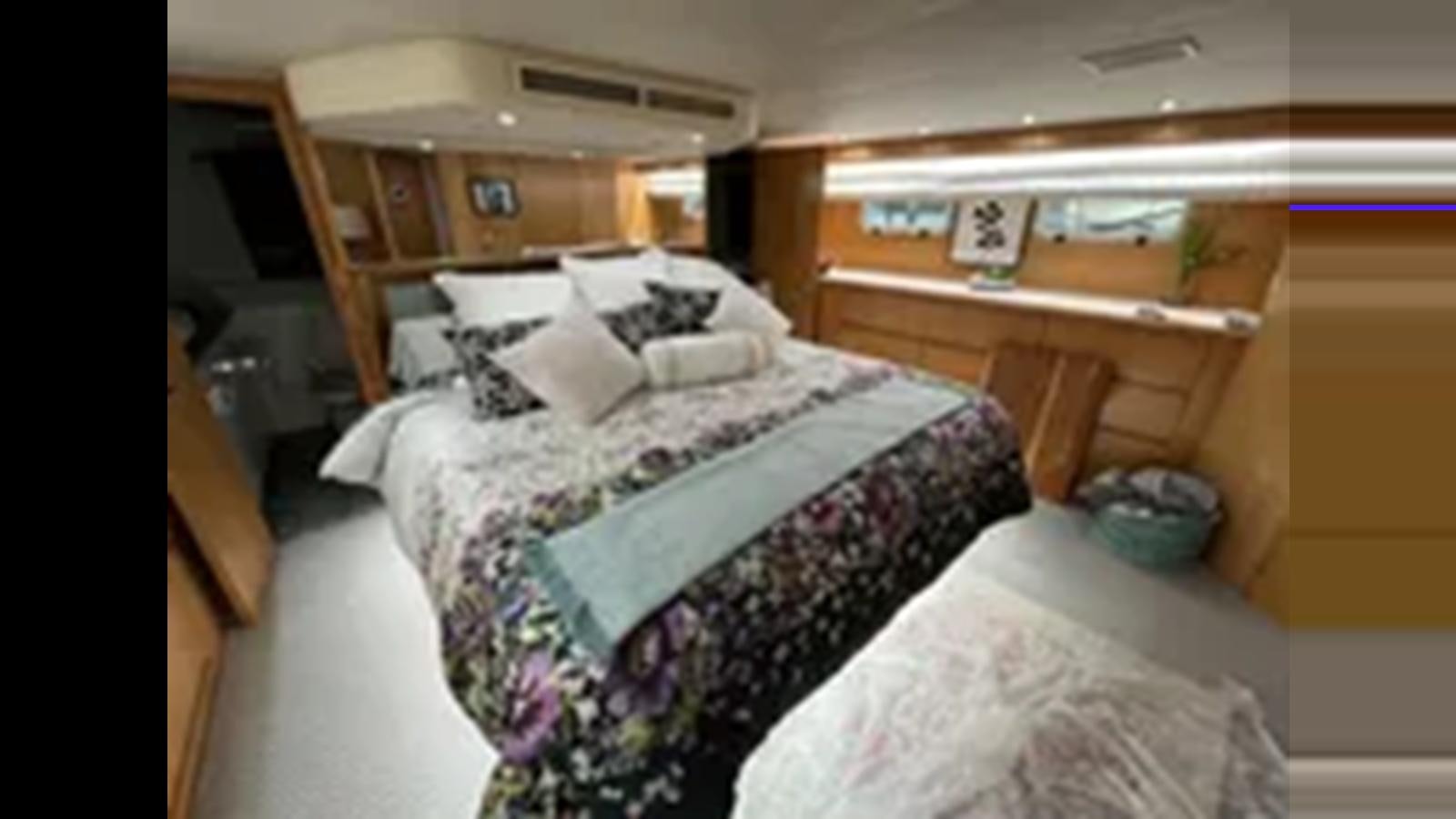 a couple of beds in a room aboard 1999 HATTERAS 74 SPORT DECK MOTOR YACHT Yacht for Sale
