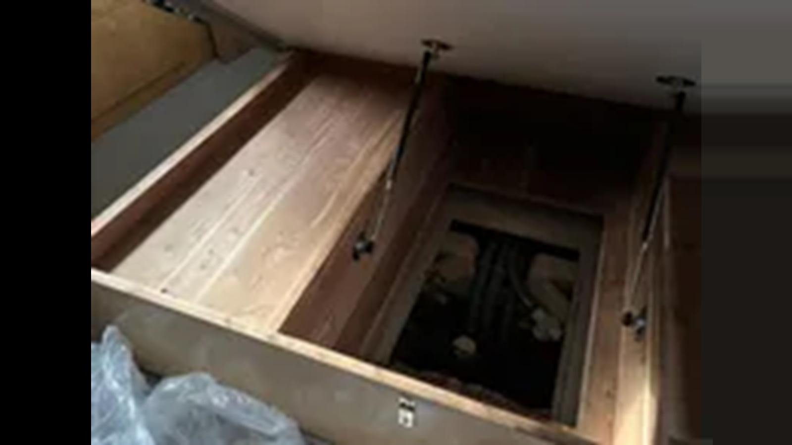 a wooden cabinet with a door aboard 1999 HATTERAS 74 SPORT DECK MOTOR YACHT Yacht for Sale