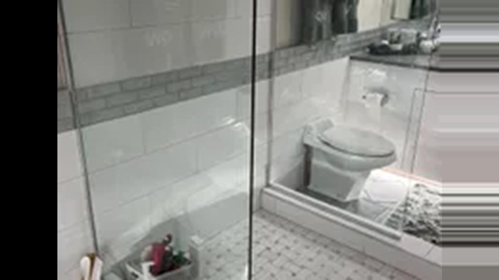 a bathroom with a glass shower aboard 1999 HATTERAS 74 SPORT DECK MOTOR YACHT Yacht for Sale