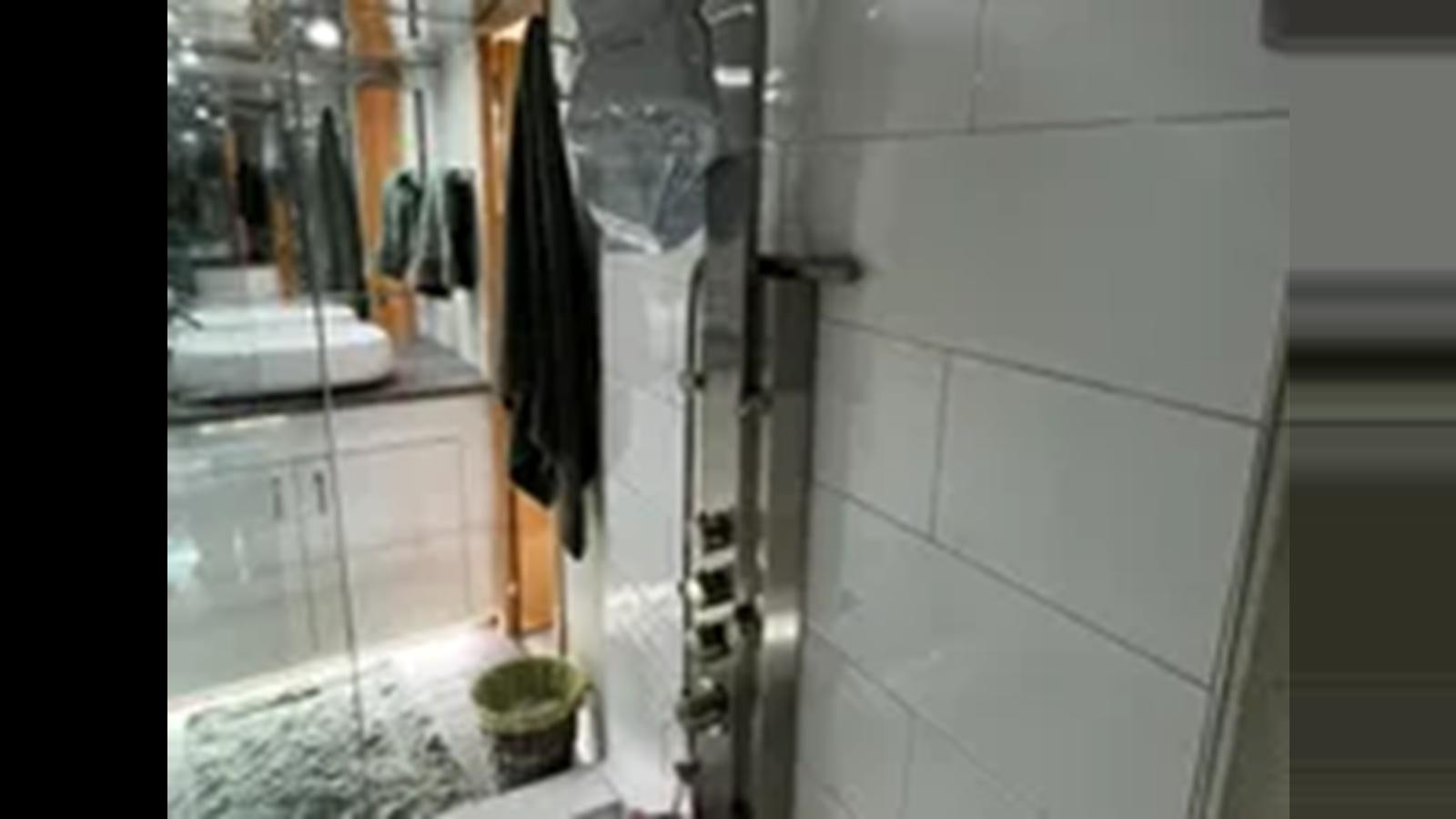 a bathroom with a shower aboard 1999 HATTERAS 74 SPORT DECK MOTOR YACHT Yacht for Sale