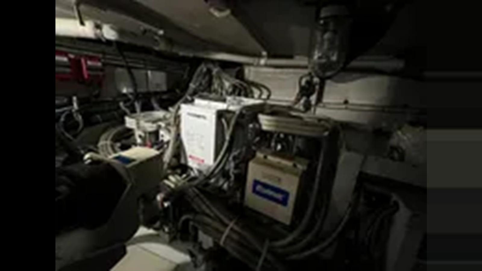 a close-up of a car engine aboard 1999 HATTERAS 74 SPORT DECK MOTOR YACHT Yacht for Sale
