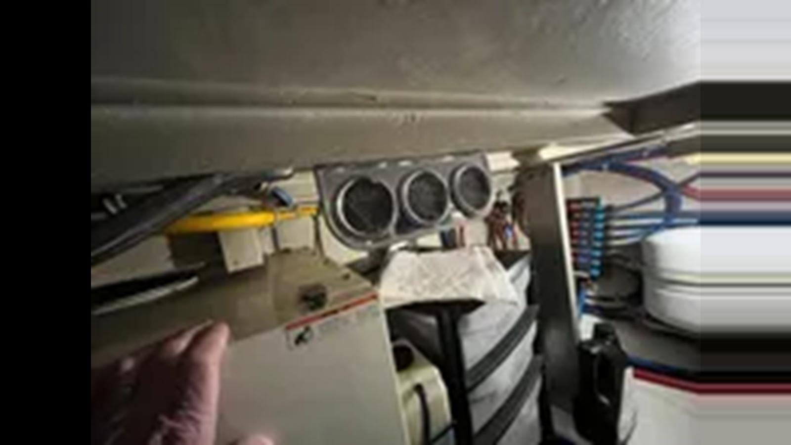a room with a fan and a chair aboard 1999 HATTERAS 74 SPORT DECK MOTOR YACHT Yacht for Sale