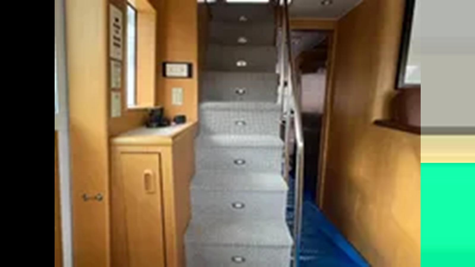 a wooden cabinet with drawers aboard 1999 HATTERAS 74 SPORT DECK MOTOR YACHT Yacht for Sale