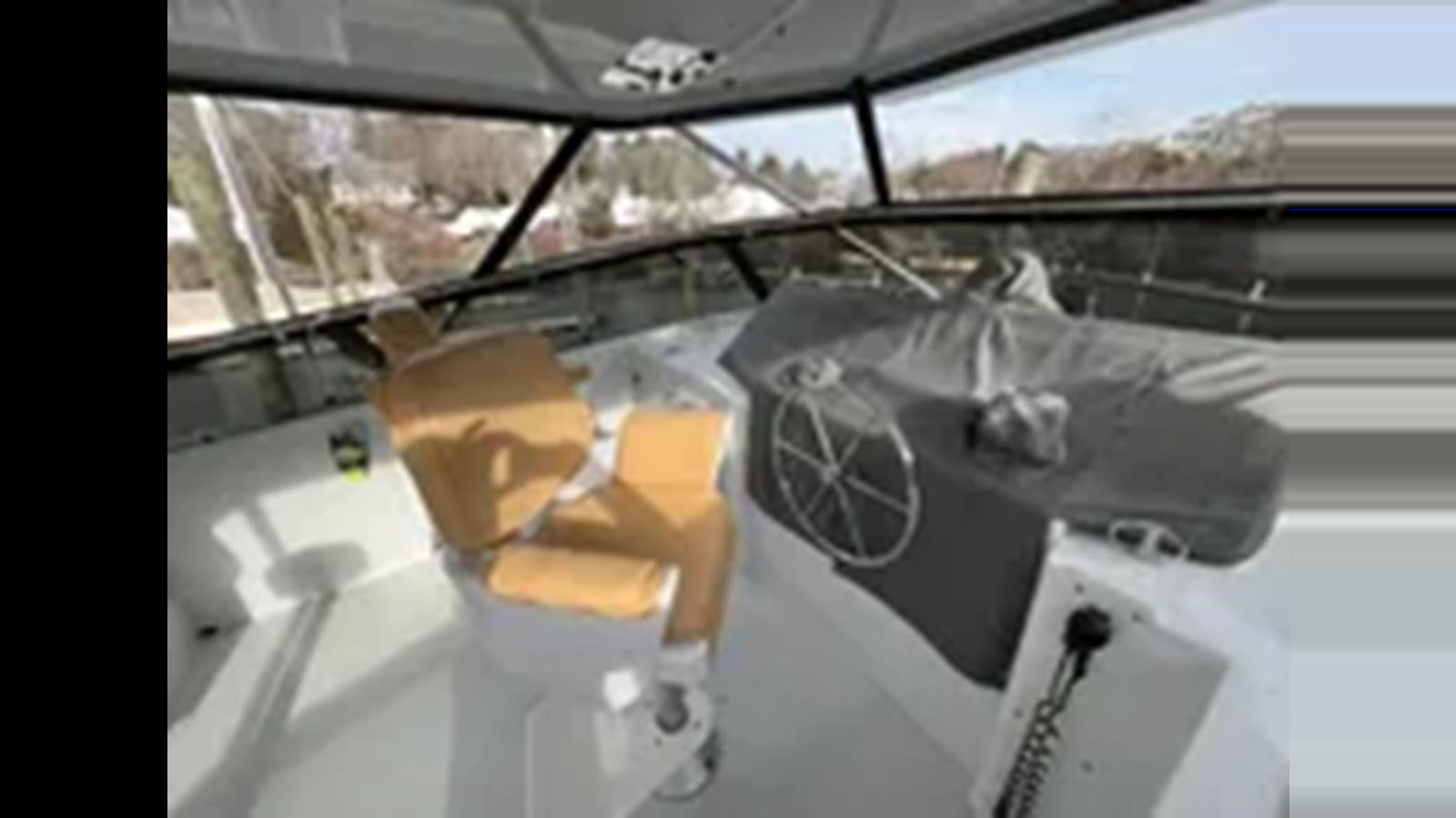 a person in a costume sitting in a car aboard 1999 HATTERAS 74 SPORT DECK MOTOR YACHT Yacht for Sale