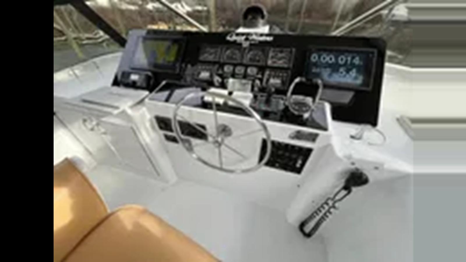 a car with a steering wheel aboard 1999 HATTERAS 74 SPORT DECK MOTOR YACHT Yacht for Sale