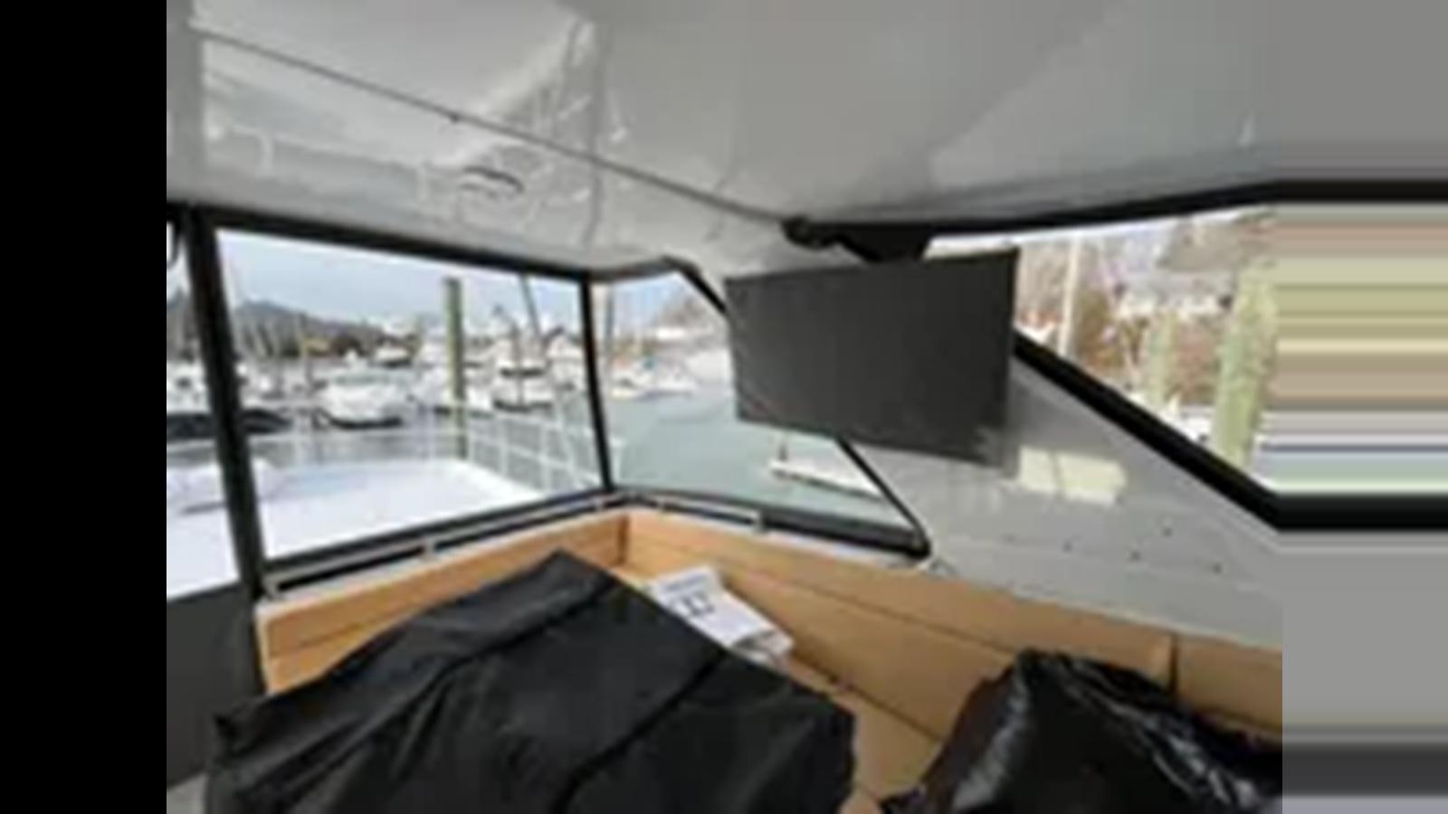 a room with a window and a desk with a computer on it aboard 1999 HATTERAS 74 SPORT DECK MOTOR YACHT Yacht for Sale