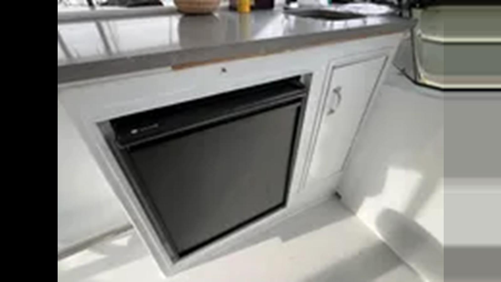a microwave oven on a counter aboard 1999 HATTERAS 74 SPORT DECK MOTOR YACHT Yacht for Sale