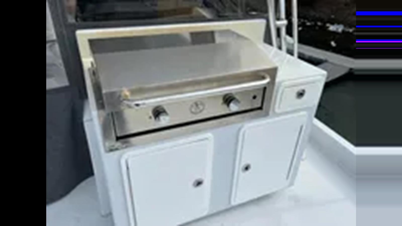 a white stove in a kitchen aboard 1999 HATTERAS 74 SPORT DECK MOTOR YACHT Yacht for Sale