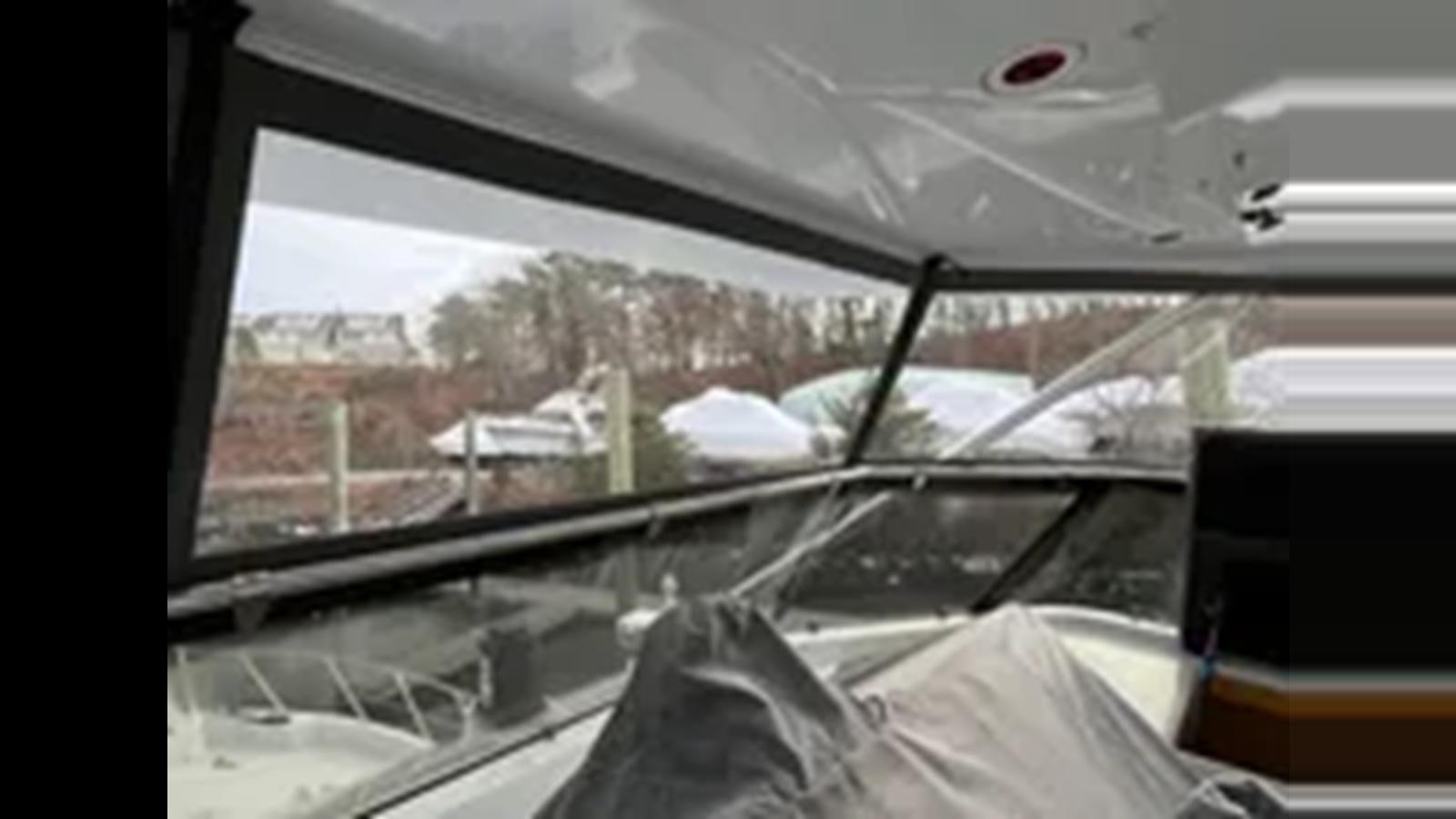 a view of a snowy yard from a window aboard 1999 HATTERAS 74 SPORT DECK MOTOR YACHT Yacht for Sale