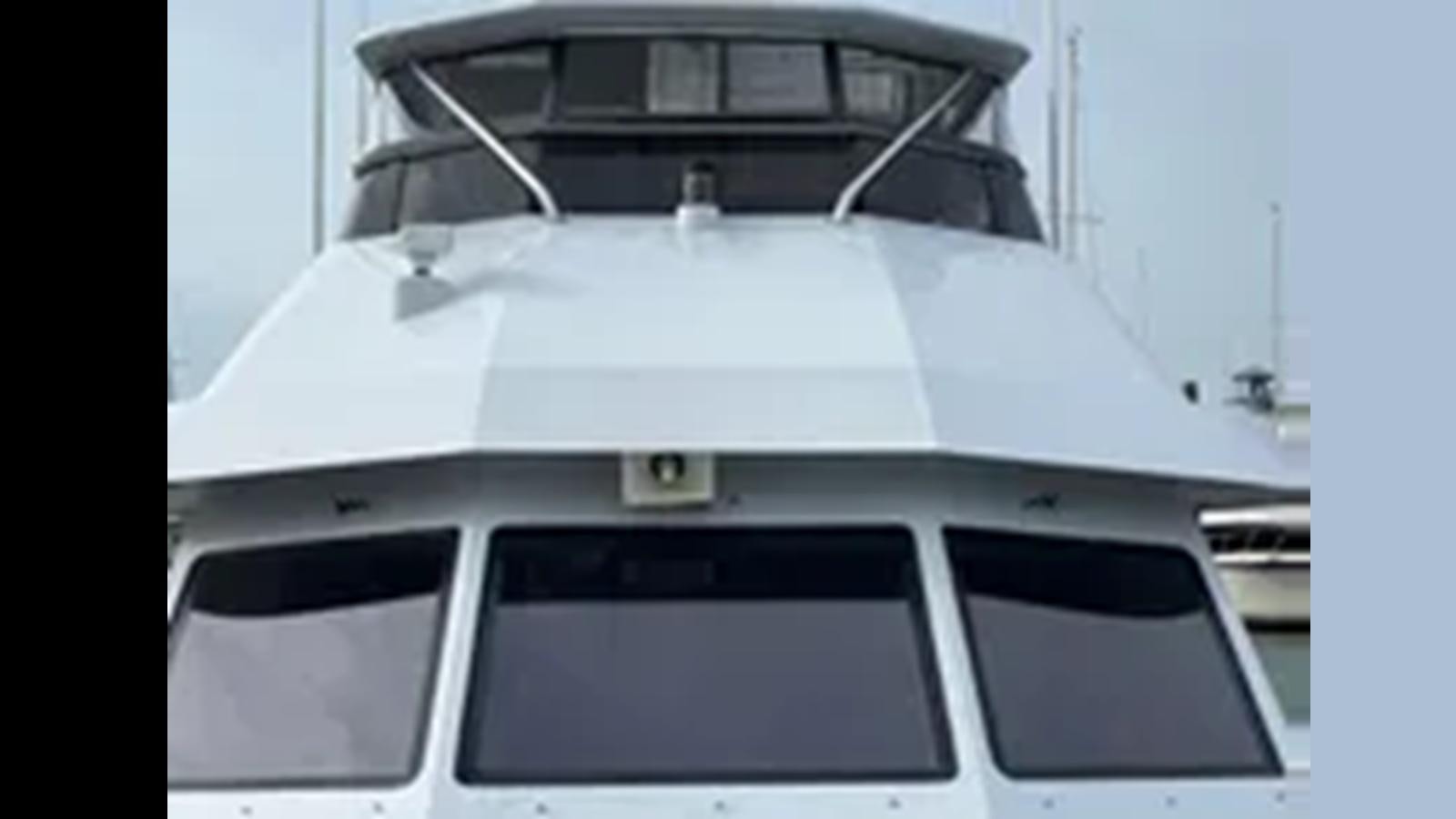a white boat with a black and silver body aboard 1999 HATTERAS 74 SPORT DECK MOTOR YACHT Yacht for Sale