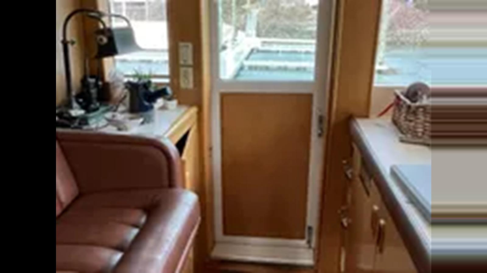 a chair in a room aboard 1999 HATTERAS 74 SPORT DECK MOTOR YACHT Yacht for Sale