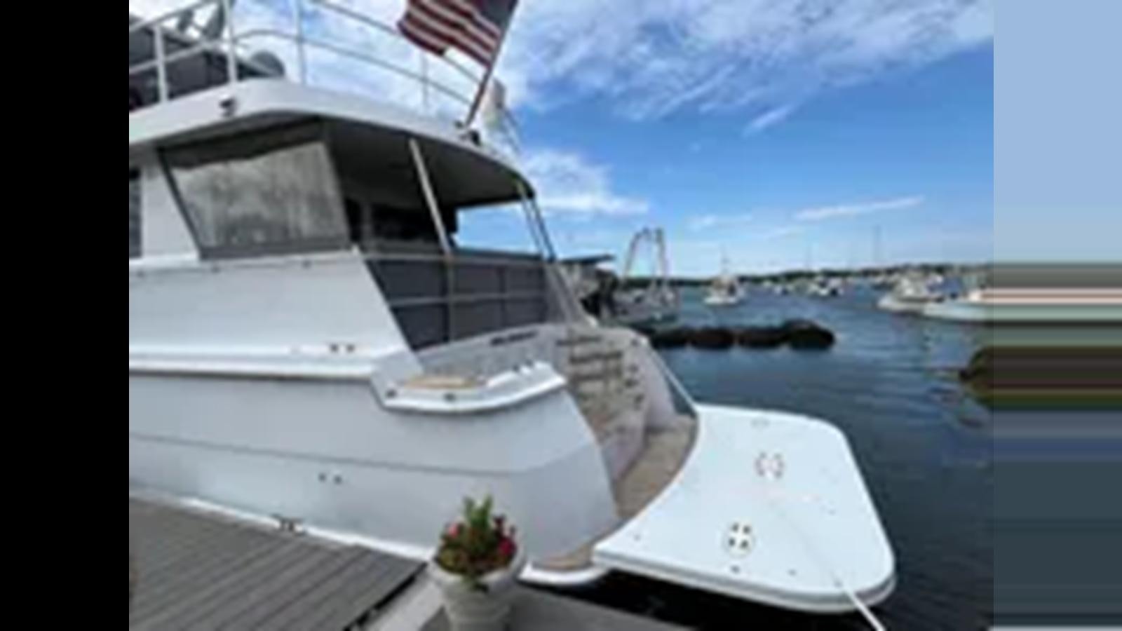 a boat on the water aboard 1999 HATTERAS 74 SPORT DECK MOTOR YACHT Yacht for Sale