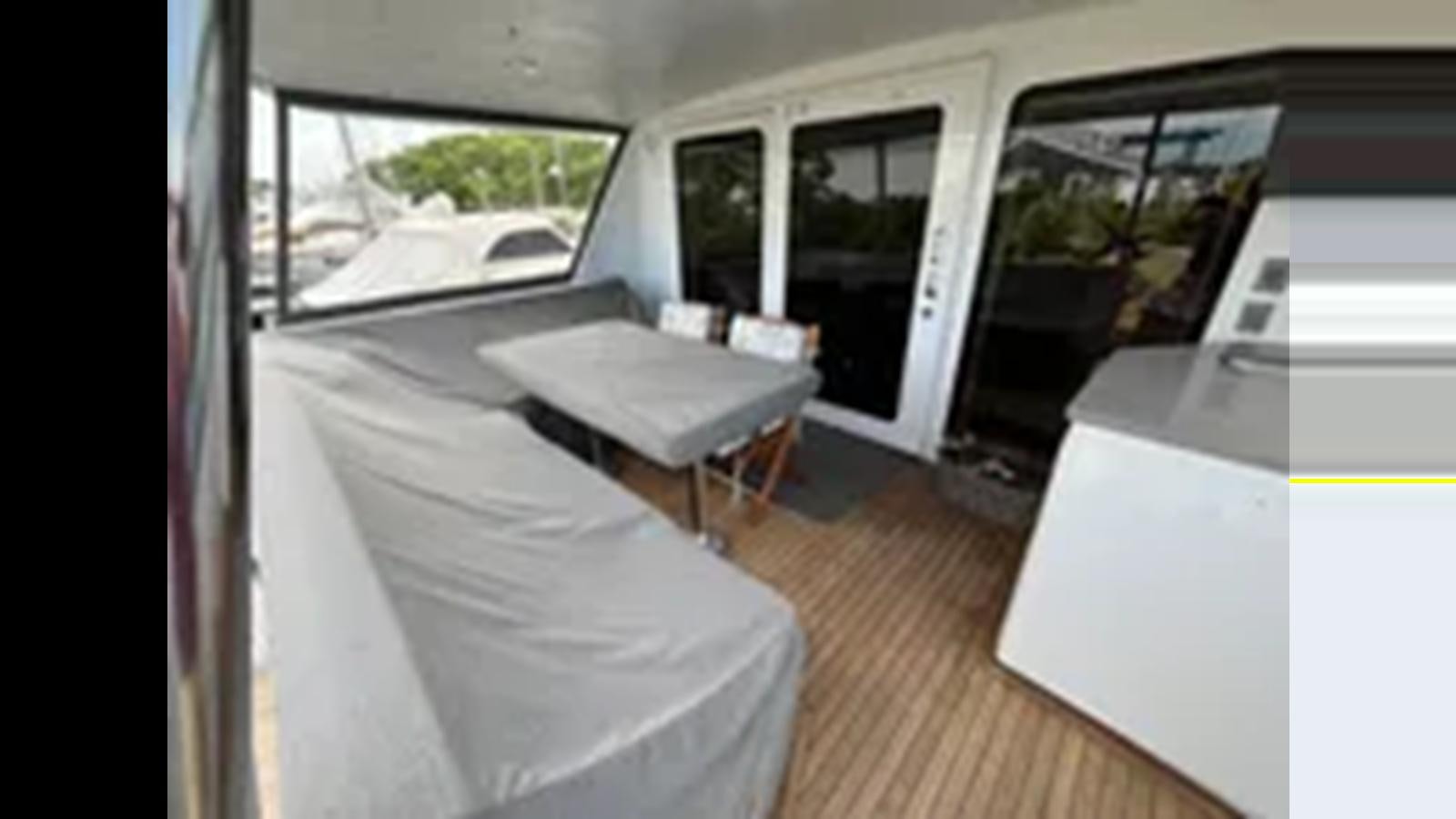 a room with a bed and a table aboard 1999 HATTERAS 74 SPORT DECK MOTOR YACHT Yacht for Sale