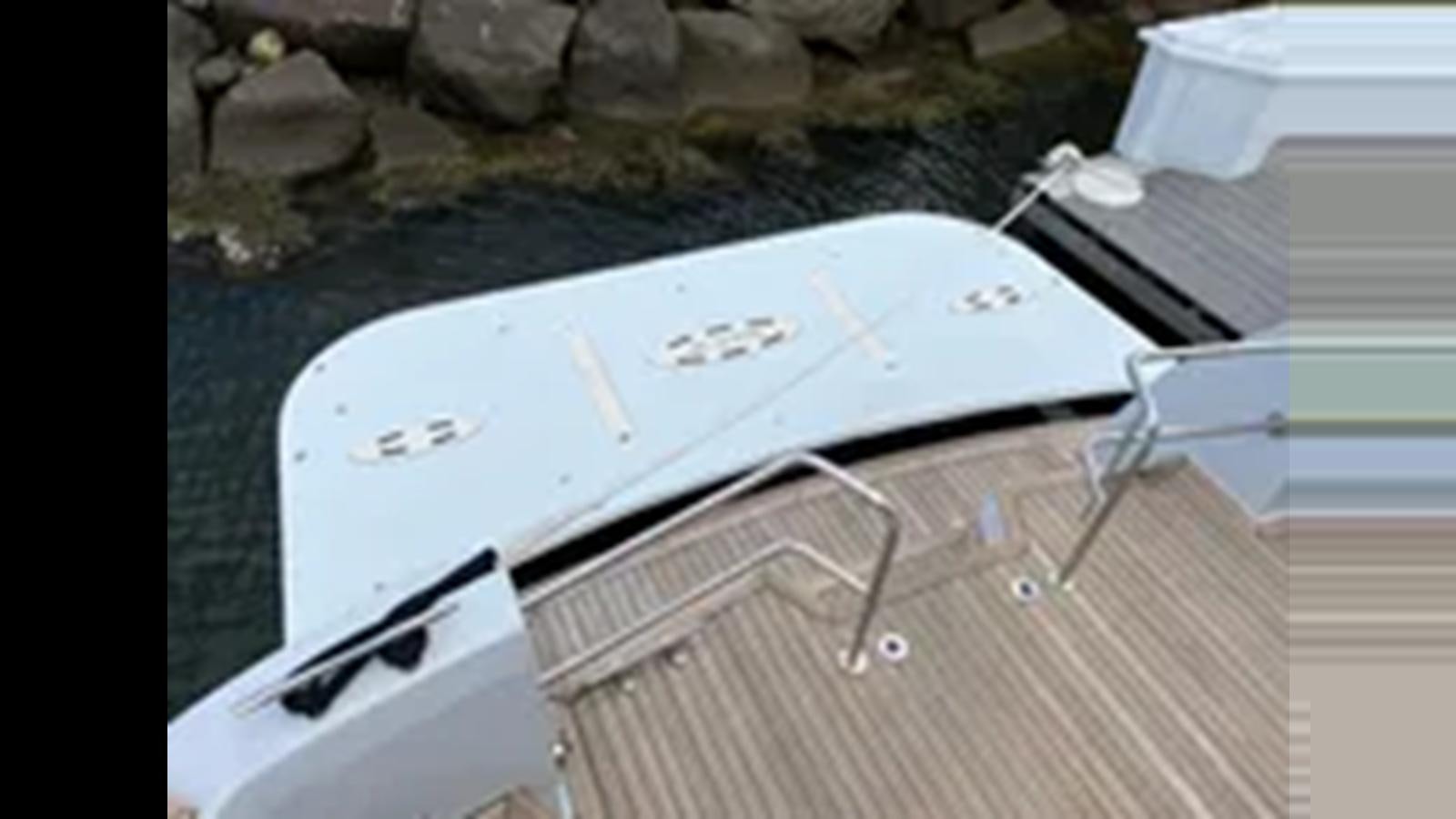 a white rectangular object with a black handle on a metal surface aboard 1999 HATTERAS 74 SPORT DECK MOTOR YACHT Yacht for Sale