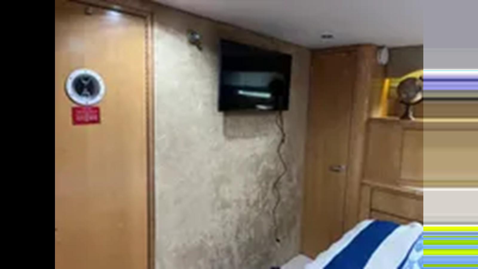 a room with a door and a window aboard 1999 HATTERAS 74 SPORT DECK MOTOR YACHT Yacht for Sale