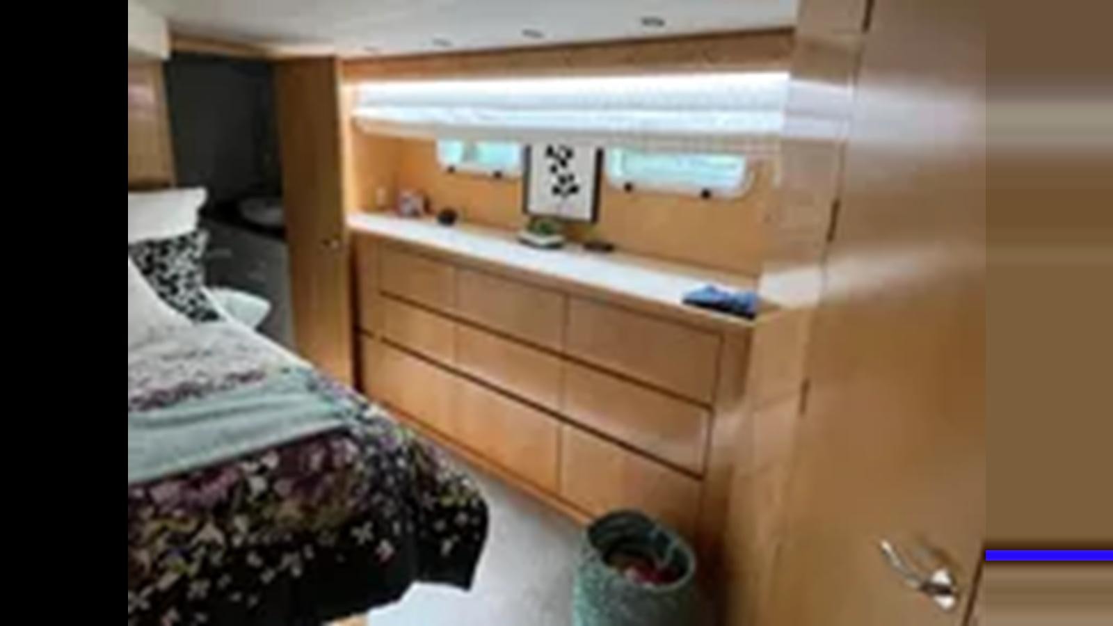 a dresser with a bed aboard 1999 HATTERAS 74 SPORT DECK MOTOR YACHT Yacht for Sale