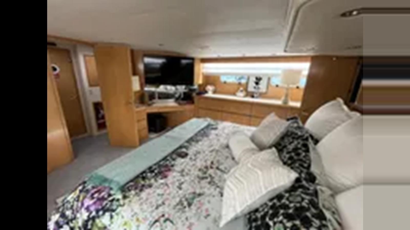 a bed in a room aboard 1999 HATTERAS 74 SPORT DECK MOTOR YACHT Yacht for Sale