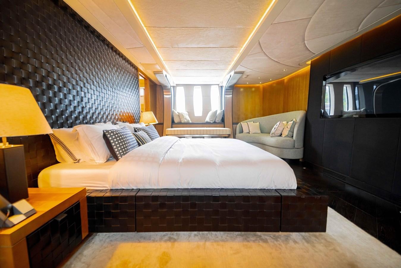 a bedroom with a bed and a couch aboard GAMMA Yacht for Sale