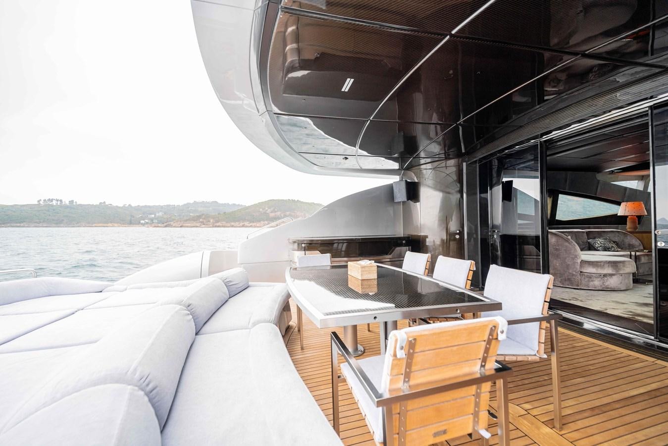 a boat with a table and chairs aboard GAMMA Yacht for Sale