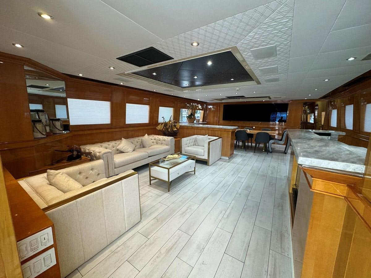 a large room with a table and chairs aboard BAGLIETTO 116 Yacht for Sale