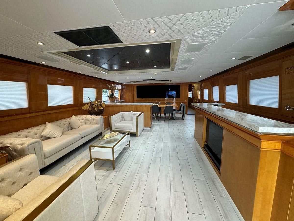 a large room with a large kitchen and living room aboard BAGLIETTO 116 Yacht for Sale