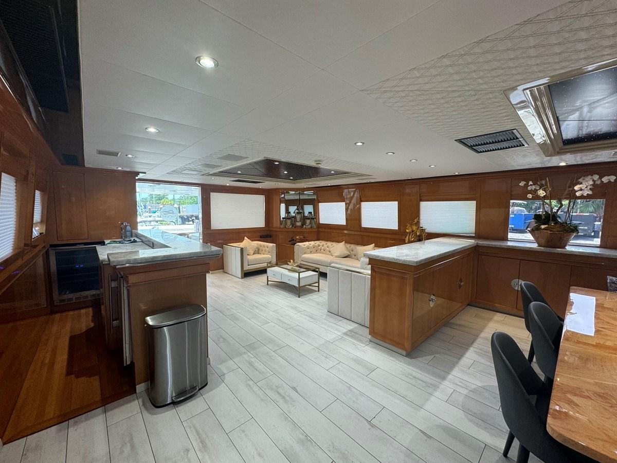 a large kitchen with wooden cabinets aboard BAGLIETTO 116 Yacht for Sale