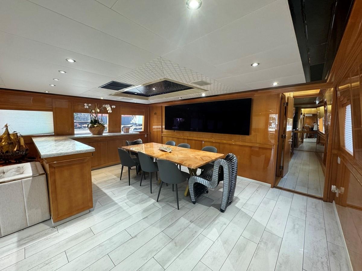 a kitchen with a table and chairs aboard BAGLIETTO 116 Yacht for Sale