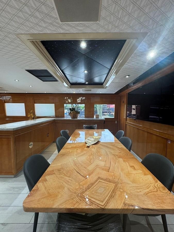 a large kitchen with a table aboard BAGLIETTO 116 Yacht for Sale