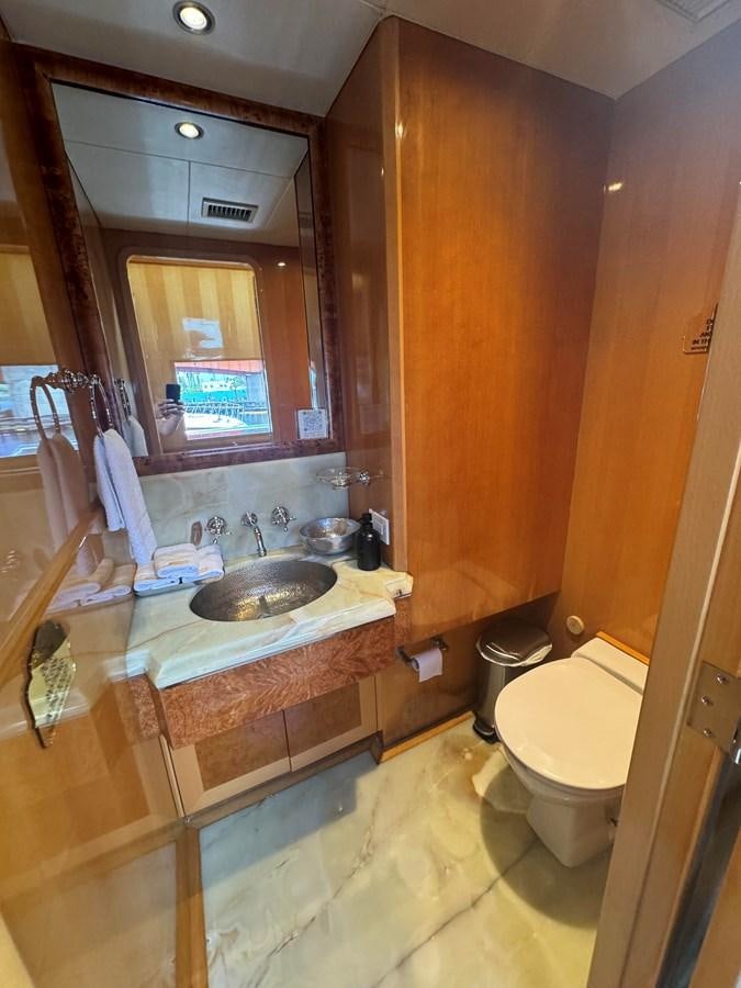 a bathroom with a sink and a toilet aboard BAGLIETTO 116 Yacht for Sale