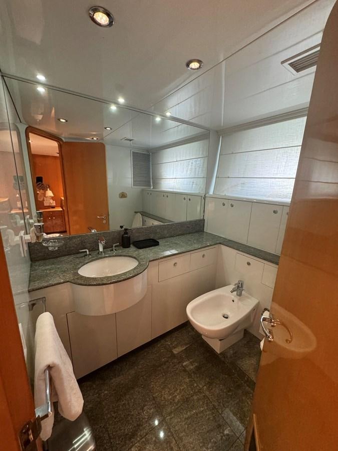 a bathroom with a large mirror aboard BAGLIETTO 116 Yacht for Sale
