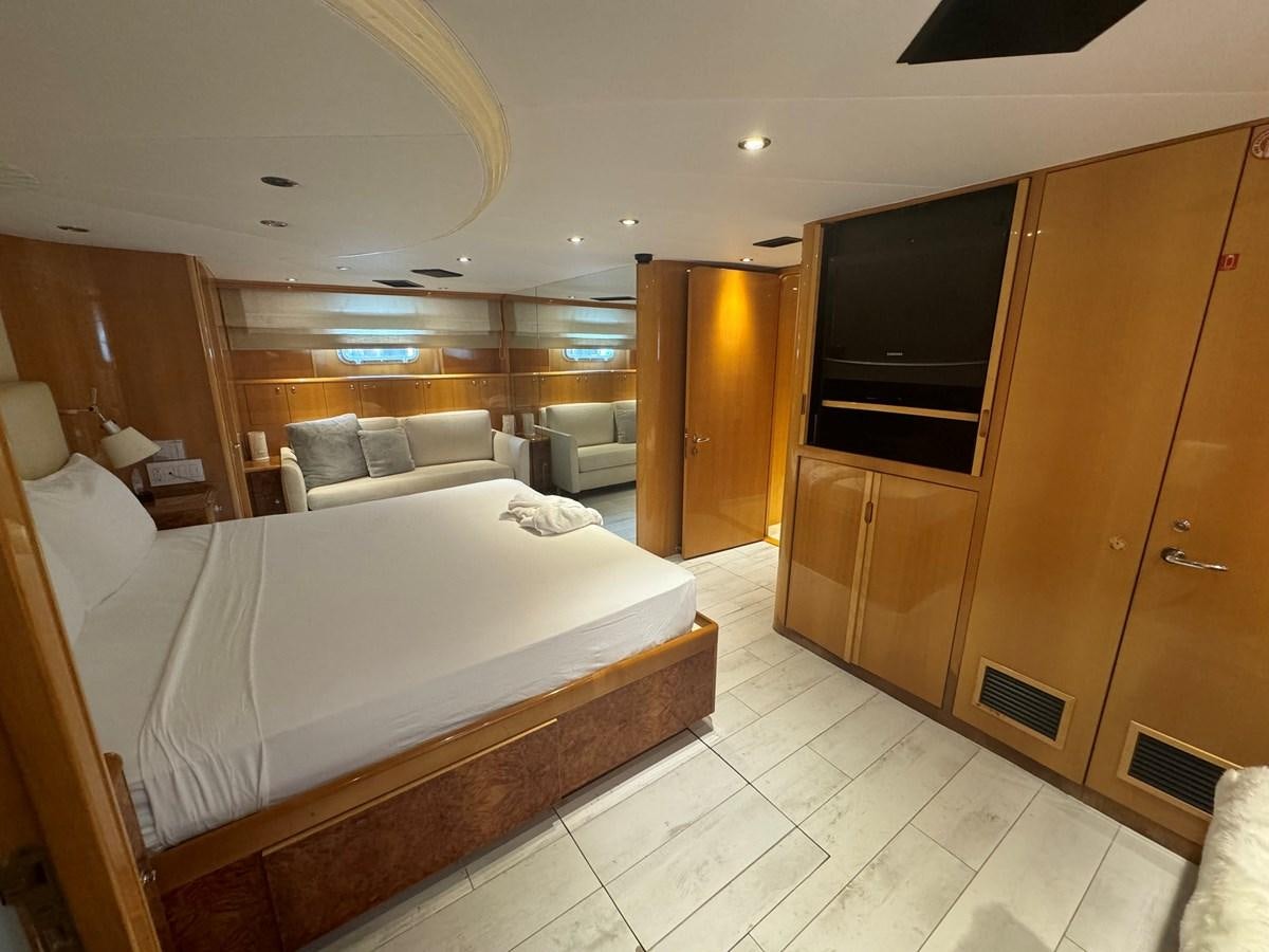 a bedroom with a bed and a tv aboard BAGLIETTO 116 Yacht for Sale