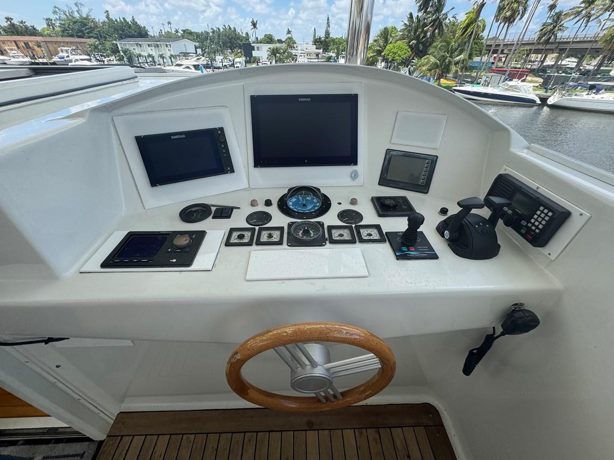 a white machine with buttons and a steering wheel on a boat aboard BAGLIETTO 116 Yacht for Sale