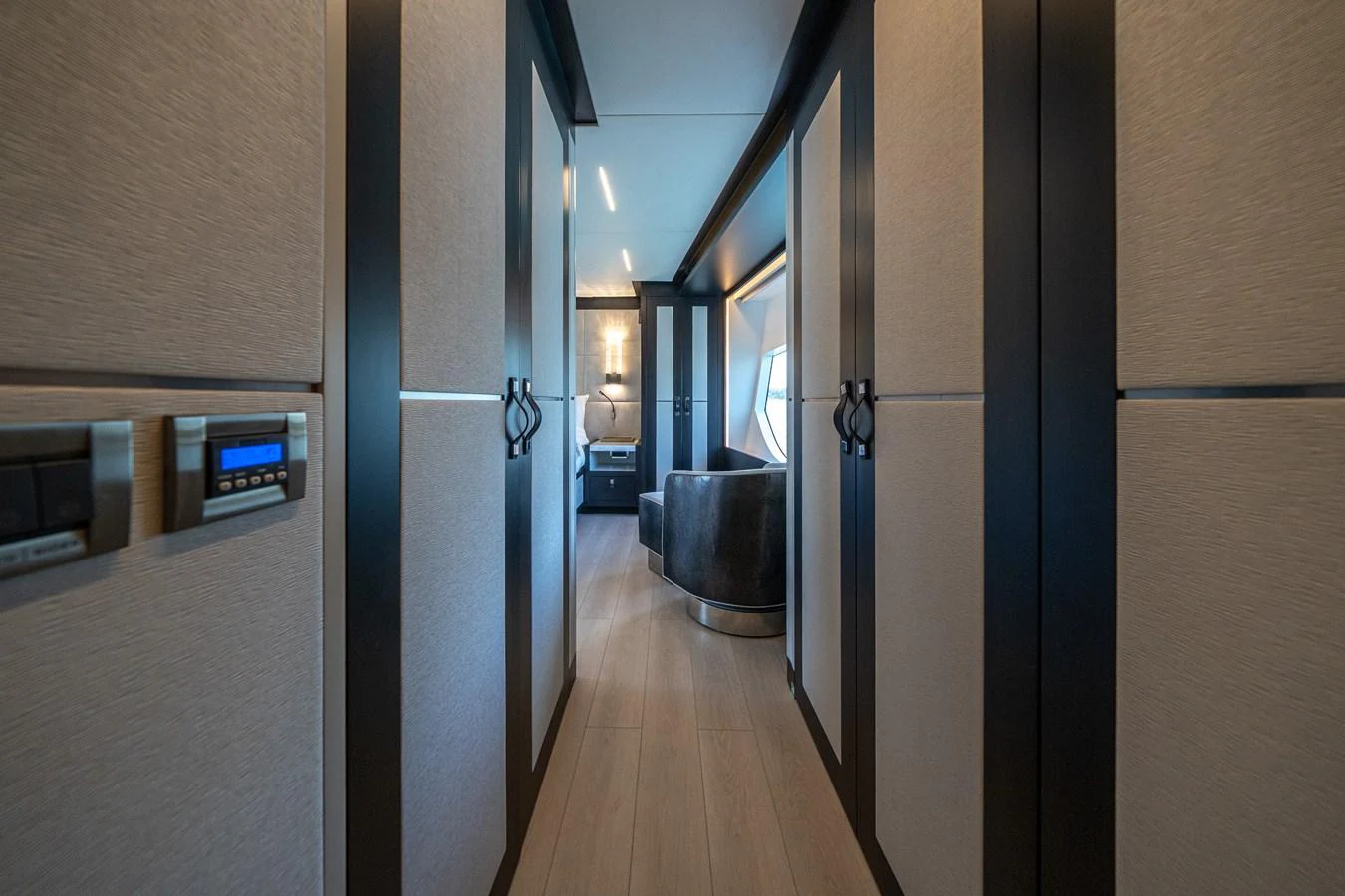 a hallway with a wood floor and a door with a window aboard DAY ONE Yacht for Sale