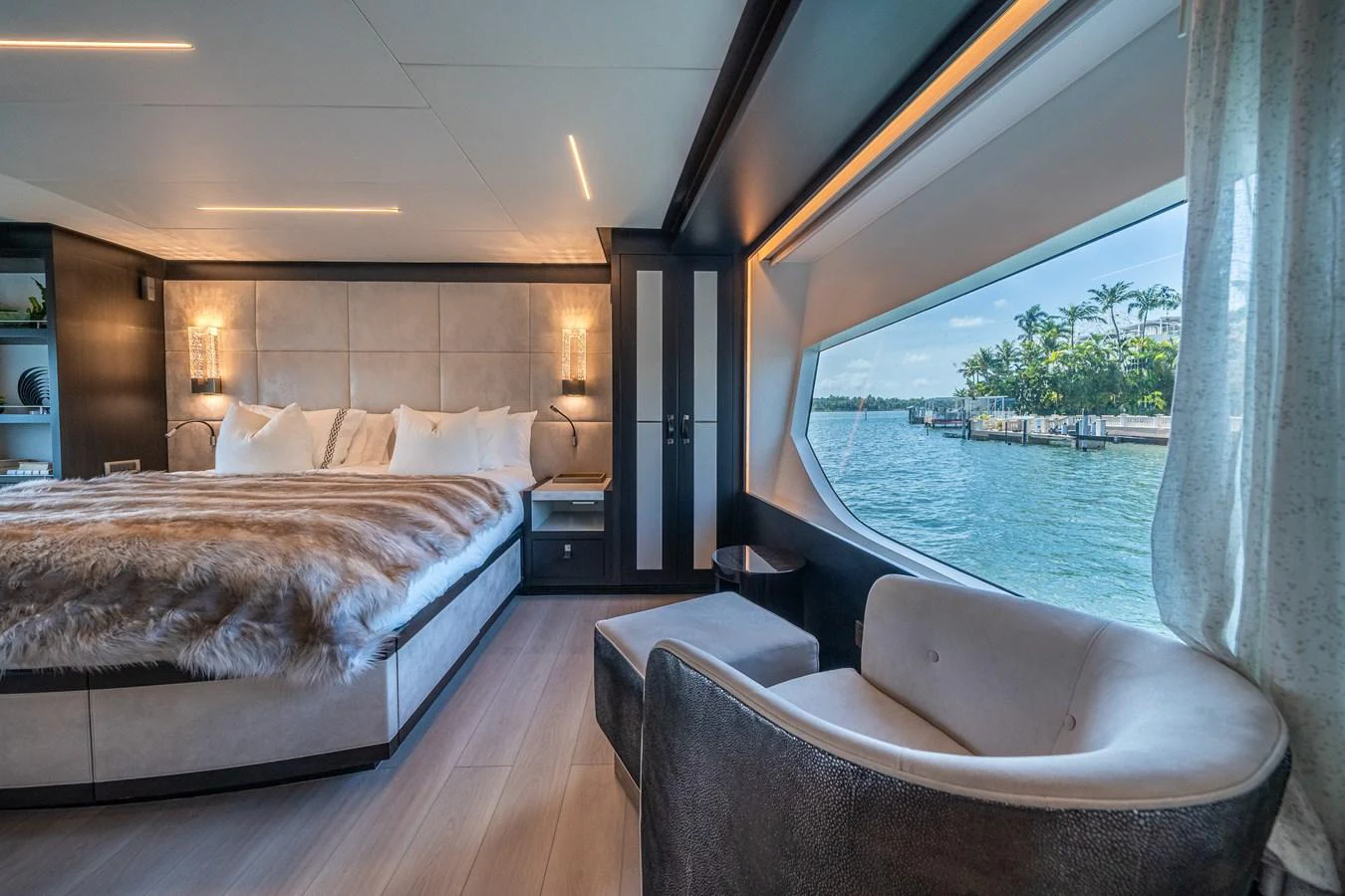 a bed and a chair in a room aboard DAY ONE Yacht for Sale