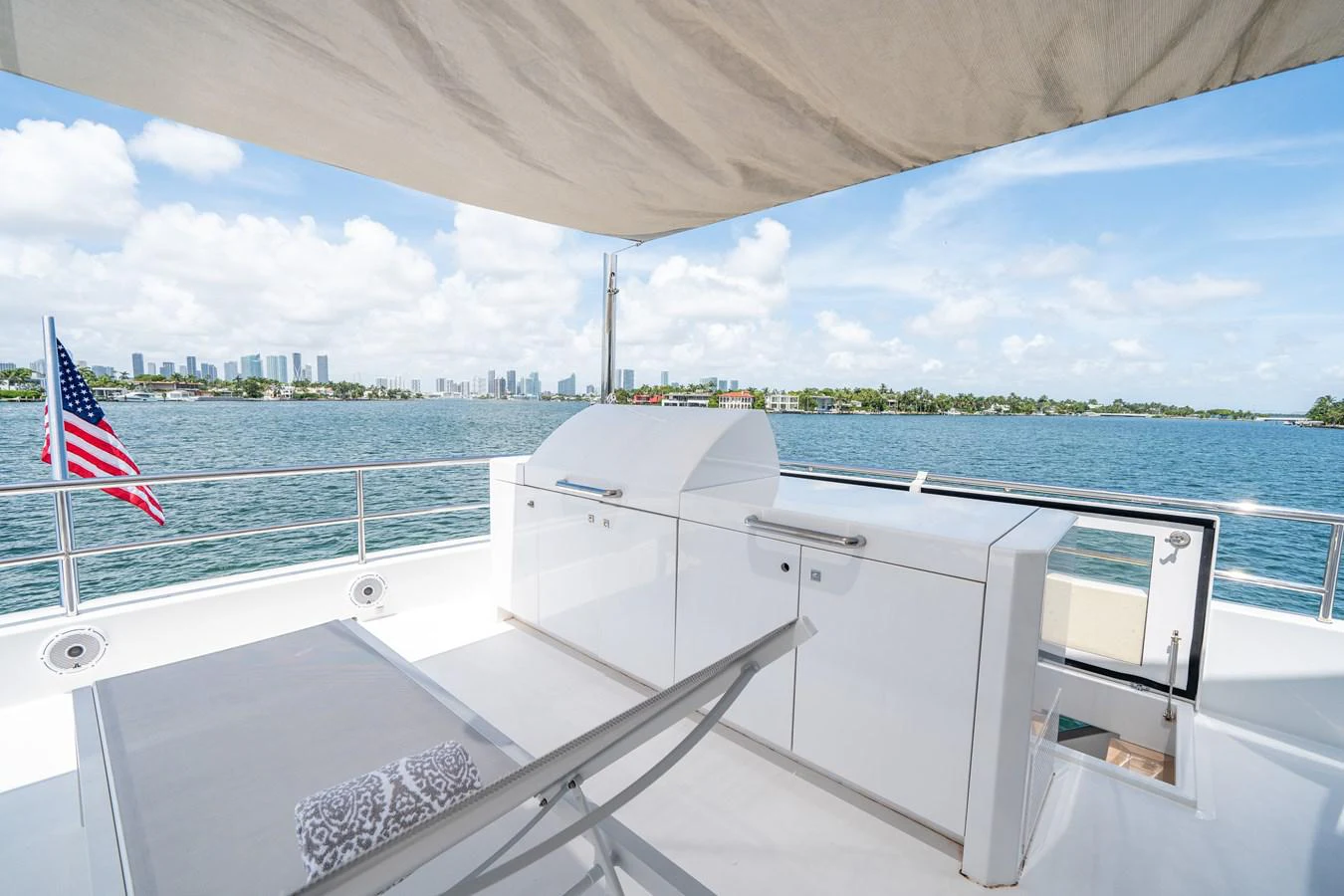 a boat with a flag on the deck aboard DAY ONE Yacht for Sale