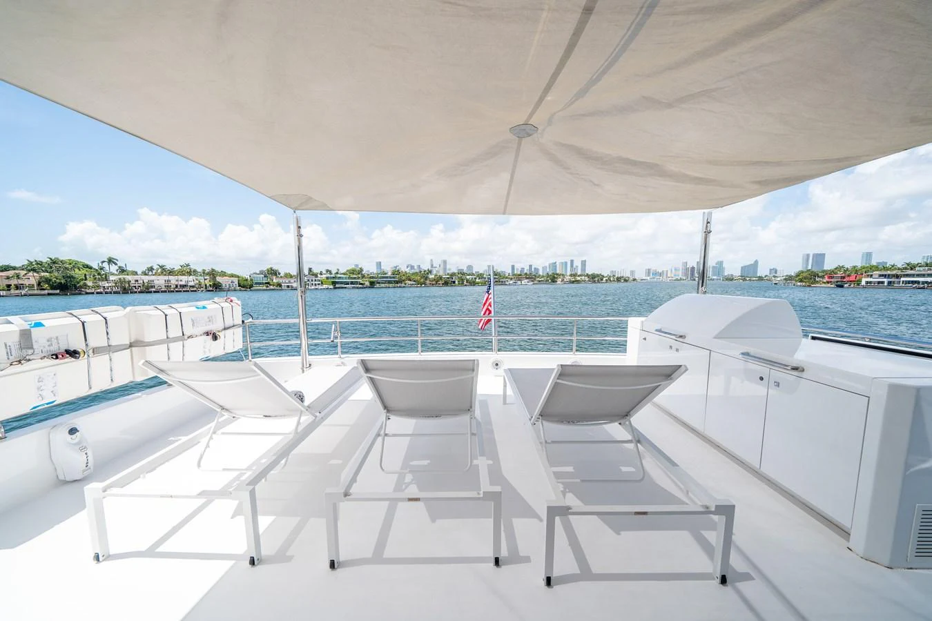a group of white chairs on a boat aboard DAY ONE Yacht for Sale