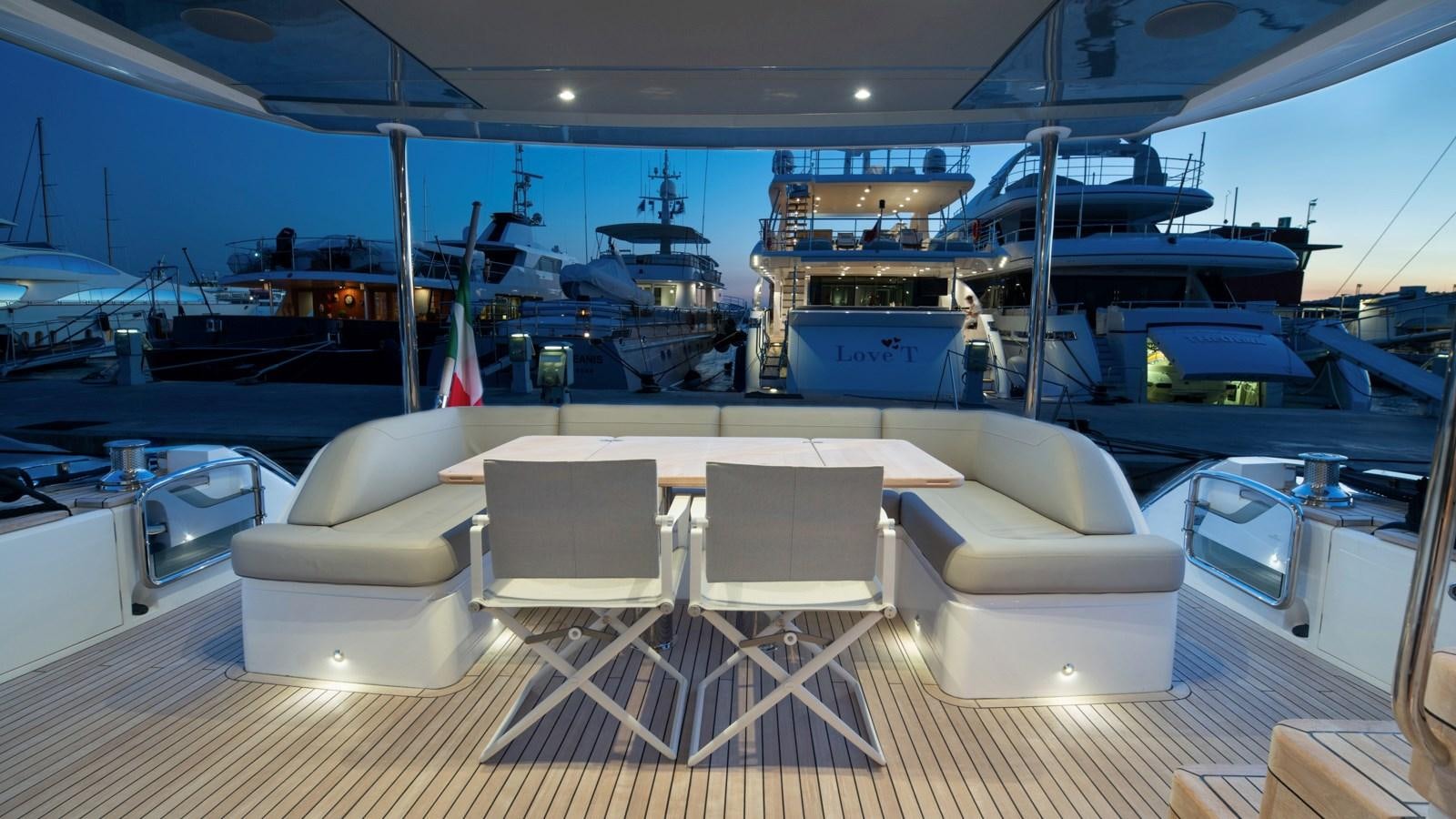 a large room with a table chairs and a boat in it aboard SERENATA Yacht for Sale