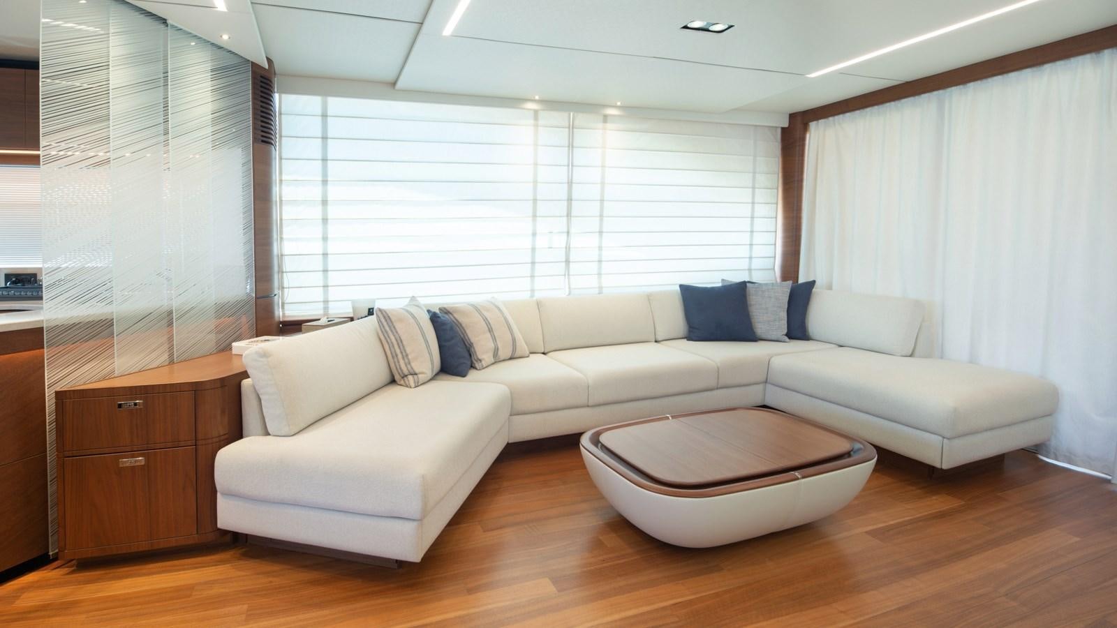a living room with a couch and a coffee table aboard SERENATA Yacht for Sale